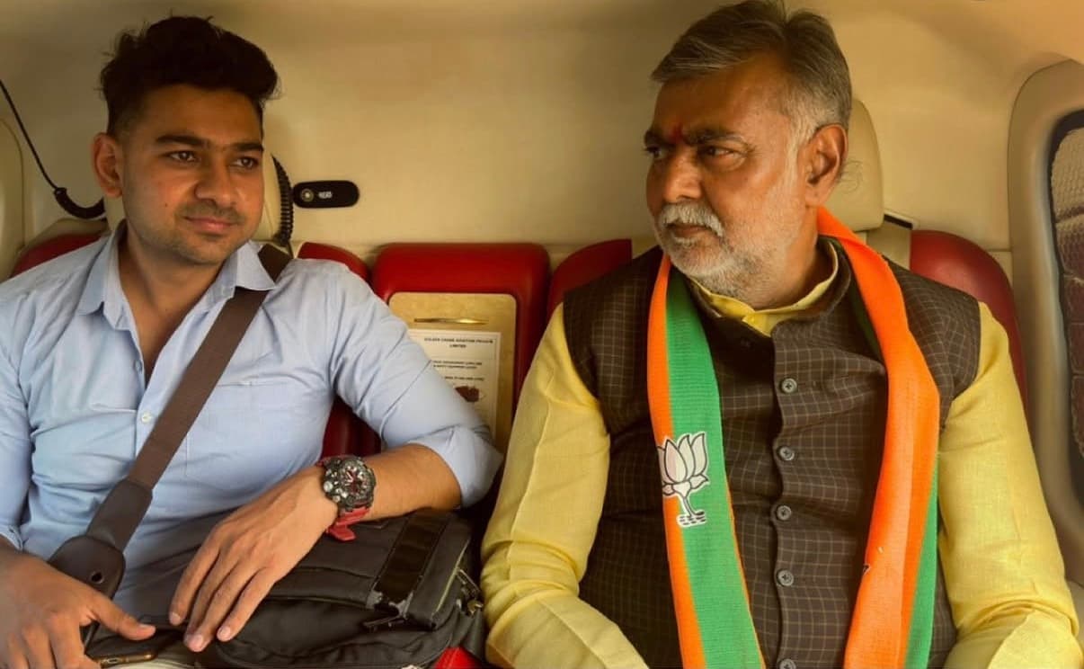 Adarsh with Cabinet Minister Prahlad Singh Patel inside a helicopter during the campaign